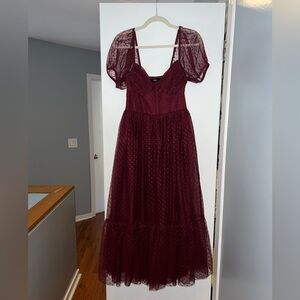 Lulu’s “Sweet Amor Burgundy Tulle Swiss Dot Tiered Bustier Midi Dress”